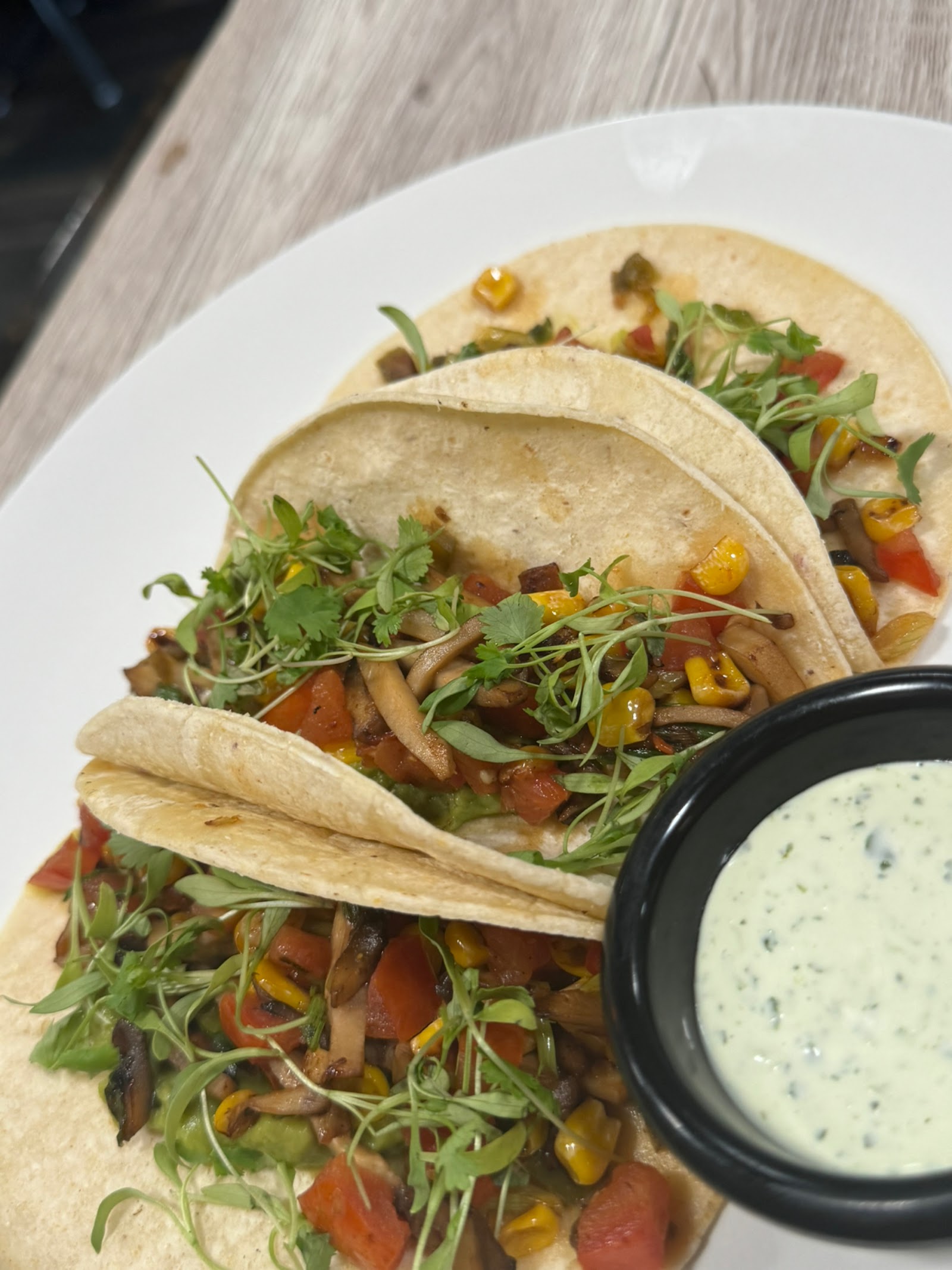 Roasted mushroom and corn tacos with cilantro crema