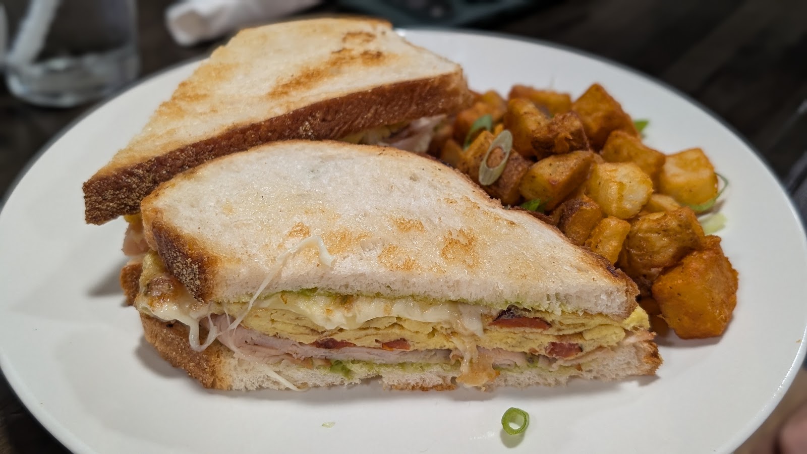 Turkey melt sandwich with crispy breakfast potatoes